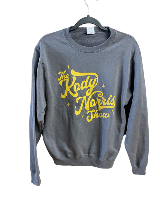 The Kody Norris Show Graphic Sweatshirt Available only in Charcoal with Gold Lettering.   Port & Co. Brand. Super Soft!  Includes small logo on back collar. 