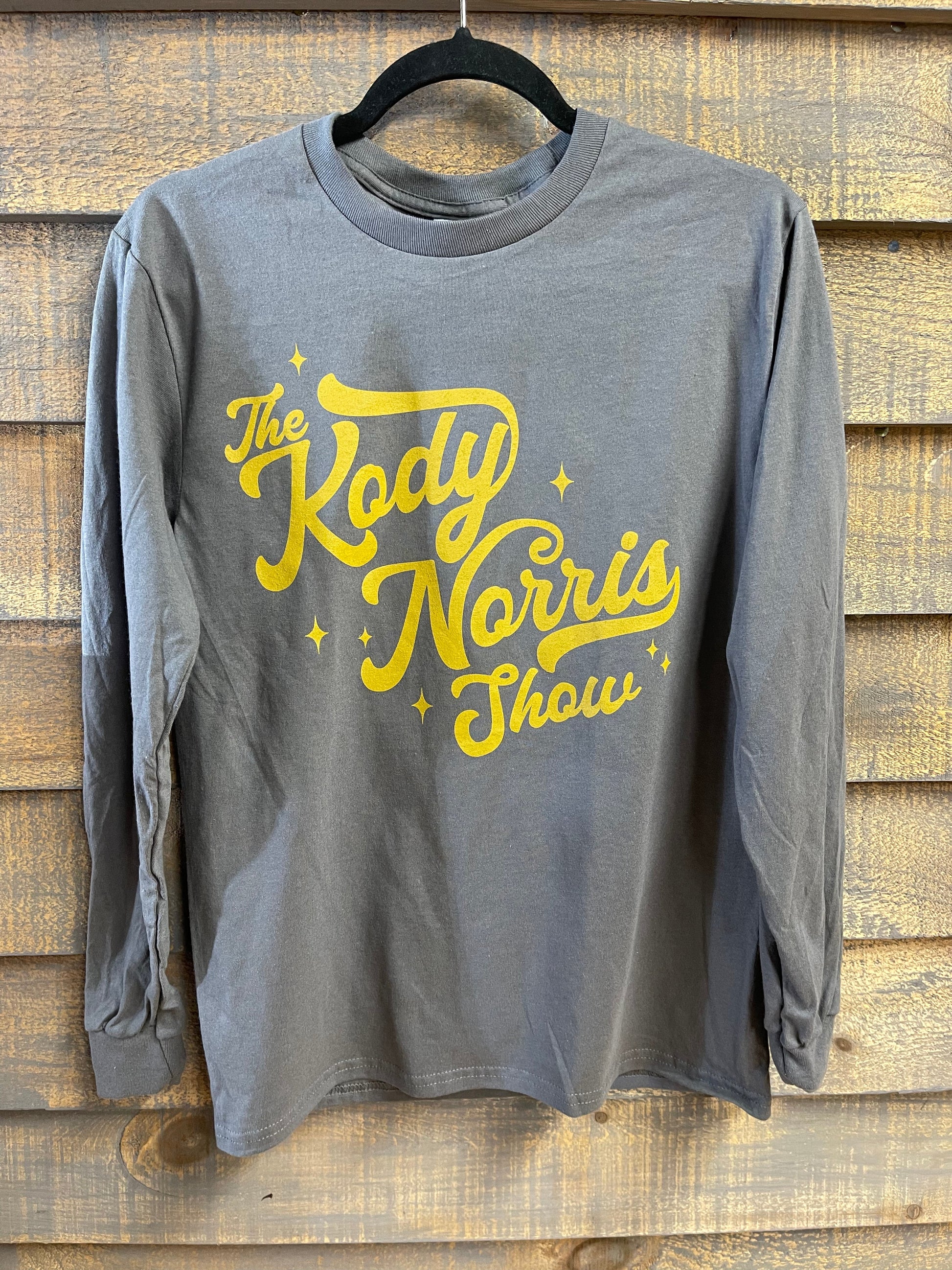 The Kody Norris Show Graphic Tee (Long Sleeve, Color Charcoal)  Charcoal with Gold Lettering.   Long Sleeve Gildan.