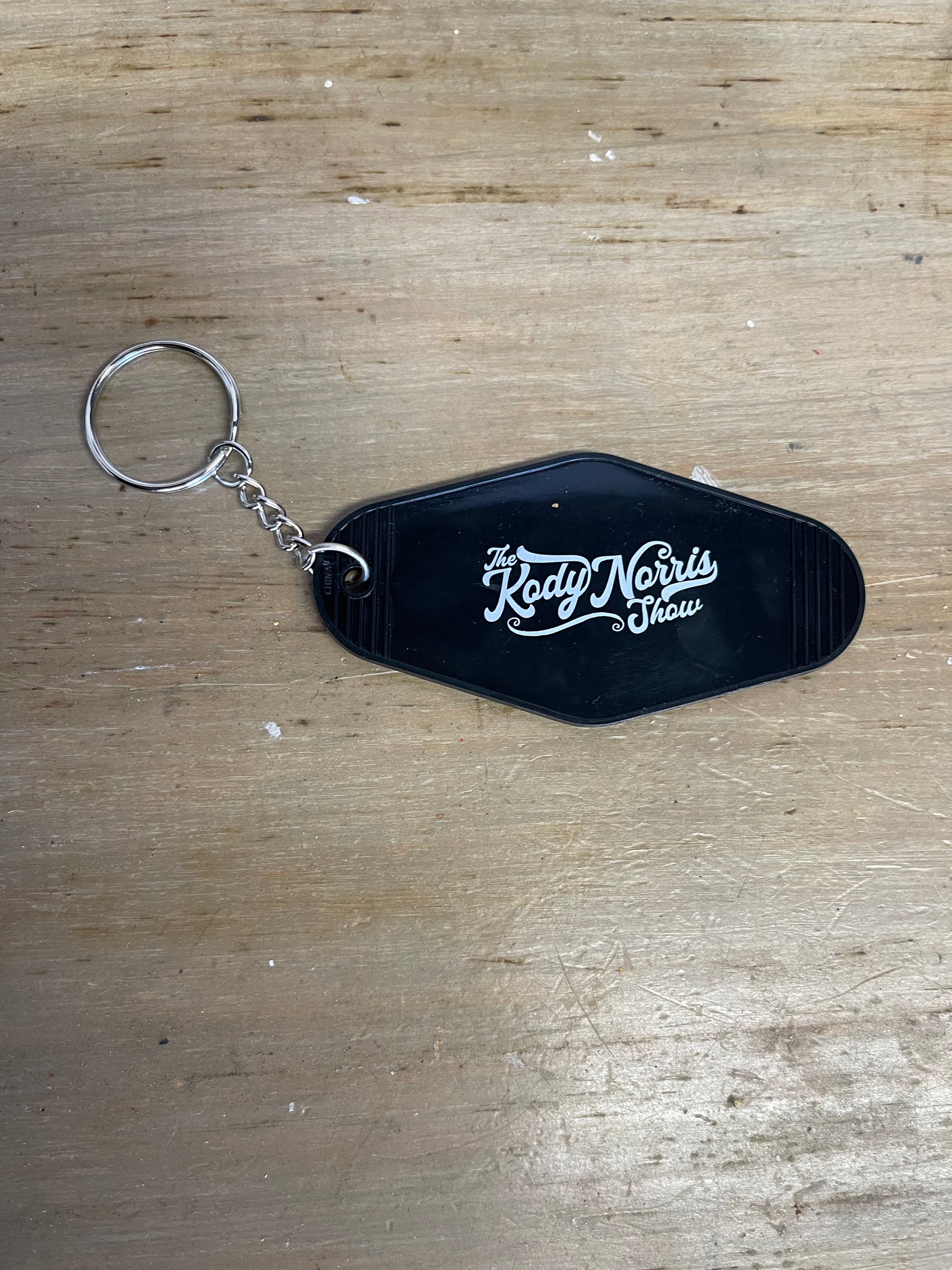 Motel Style Key Chain.   Black with White logo. One Sided
